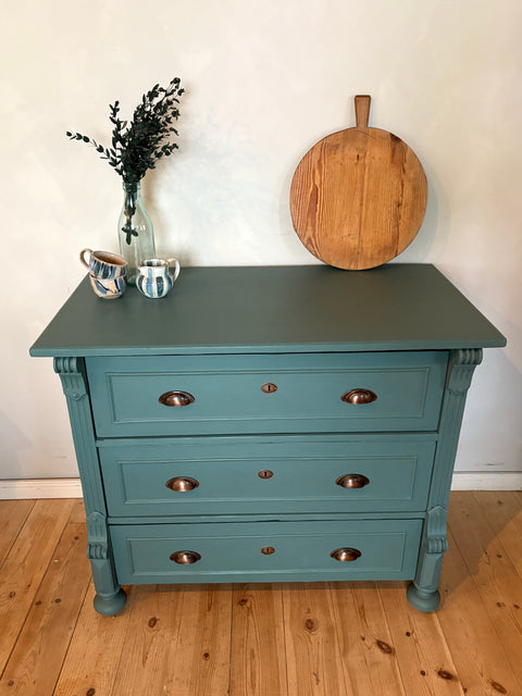 Antike Vintage Kommode in Dunkelgrün mit Kreidefarbe, stilvolle Möbel, detailreiche Oberfläche.