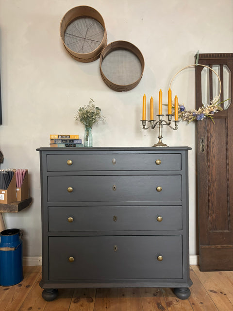 Dänische Kommode in Kreidefarbe Graphit, zeigt stilvolle Holzkommode mit eleganten Details